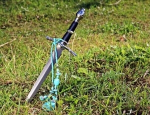 teal beaded necklace and black handled sword thumbnail