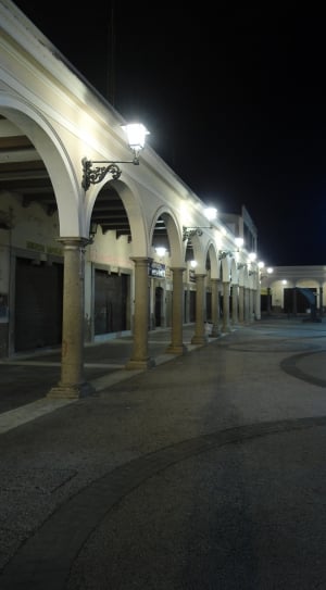 white wooden pillars with lights on in night time thumbnail