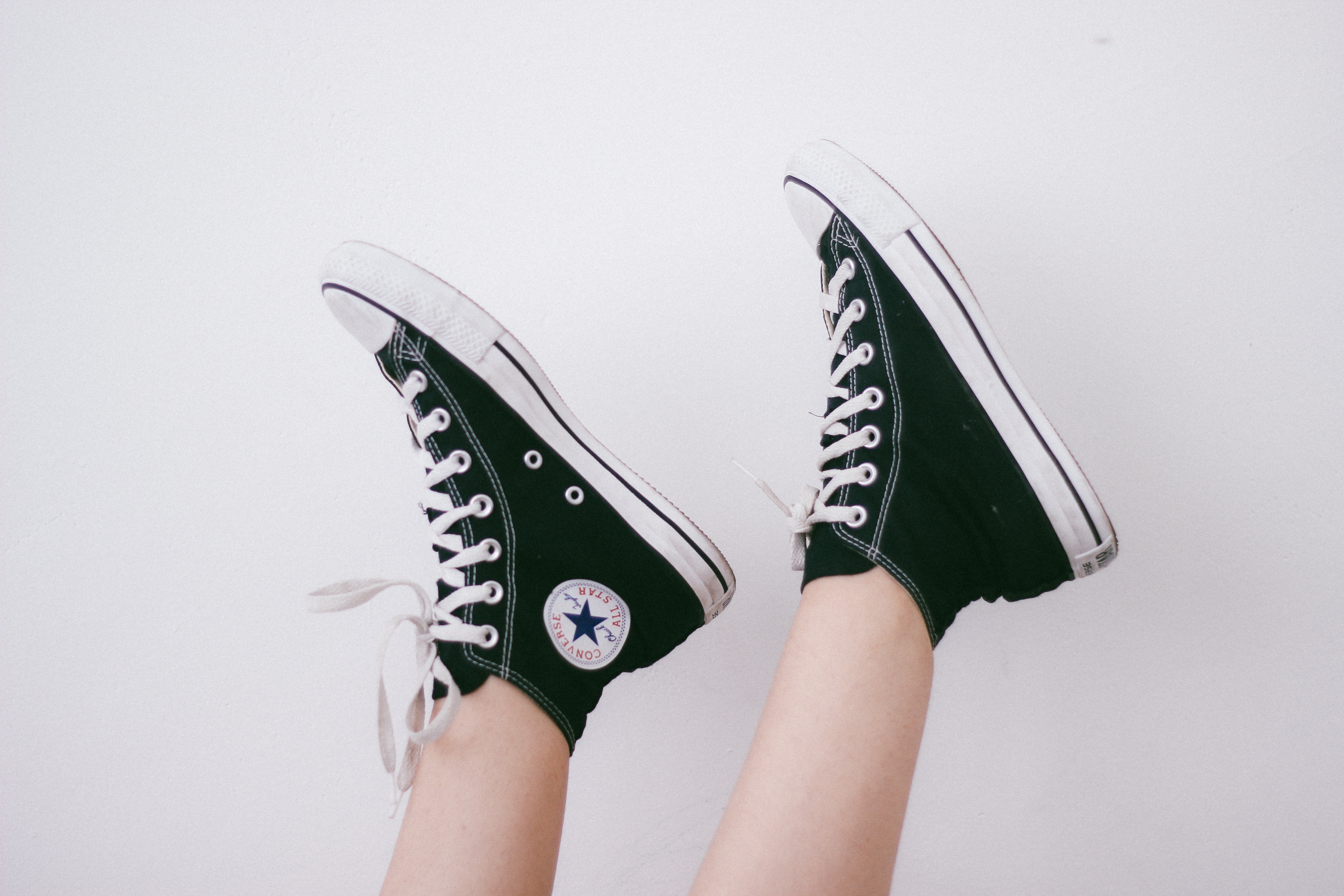 green and white converse high tops.