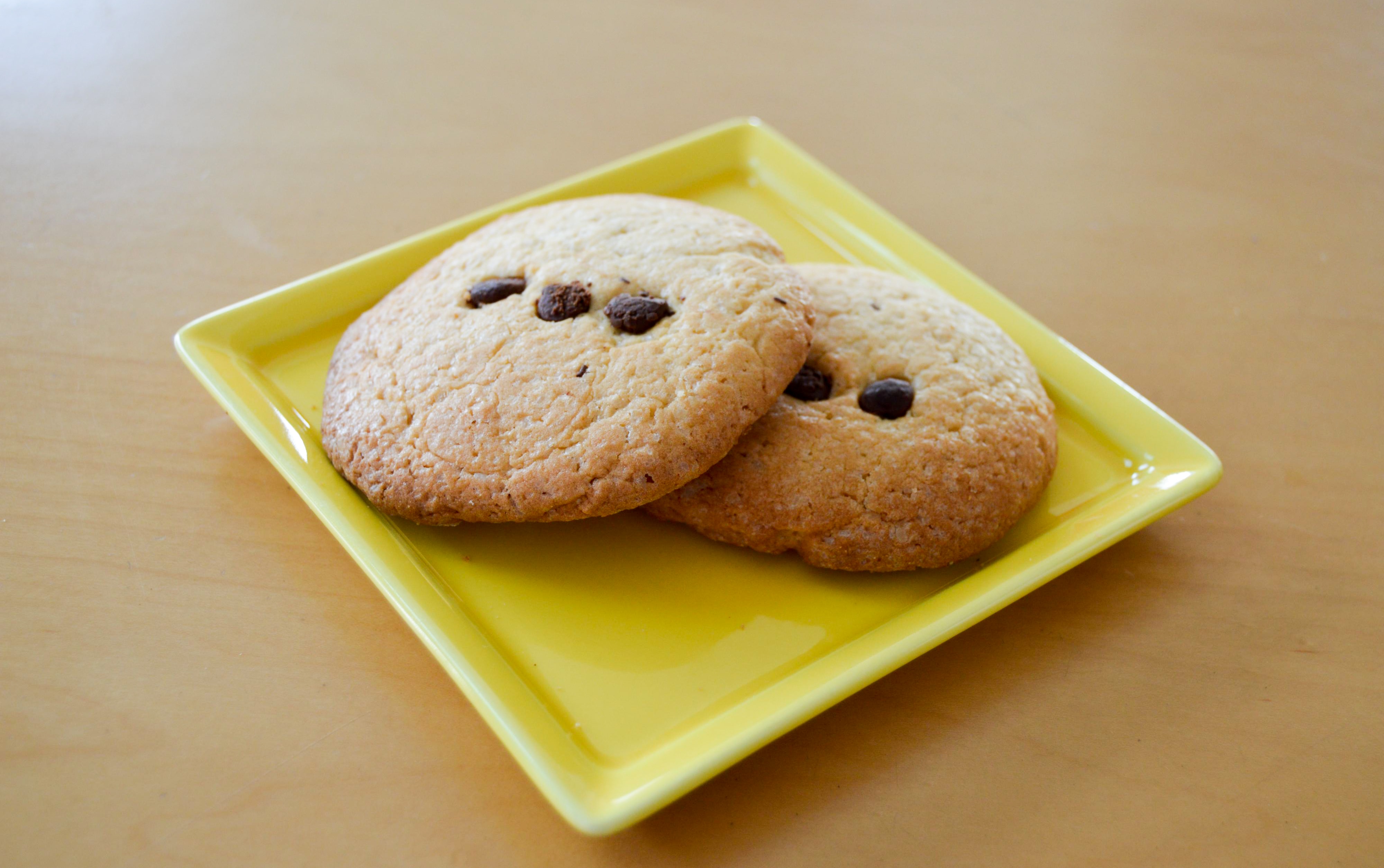 two cookies on square yellow ceramic plate