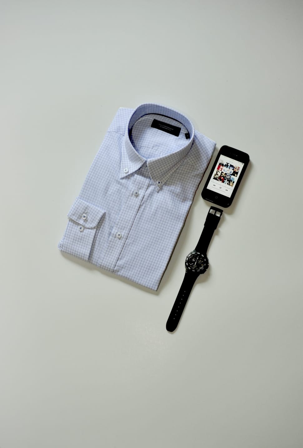blue and white checked sport shirt and ipod touch and black watch preview