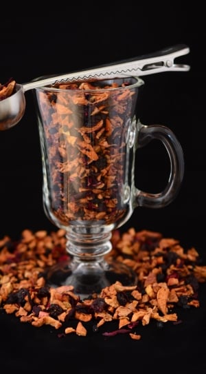 stainless steel scooper and clear glass mug filled with dried fruits thumbnail