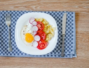 white ceramic plate with egg and vegetables on the table thumbnail