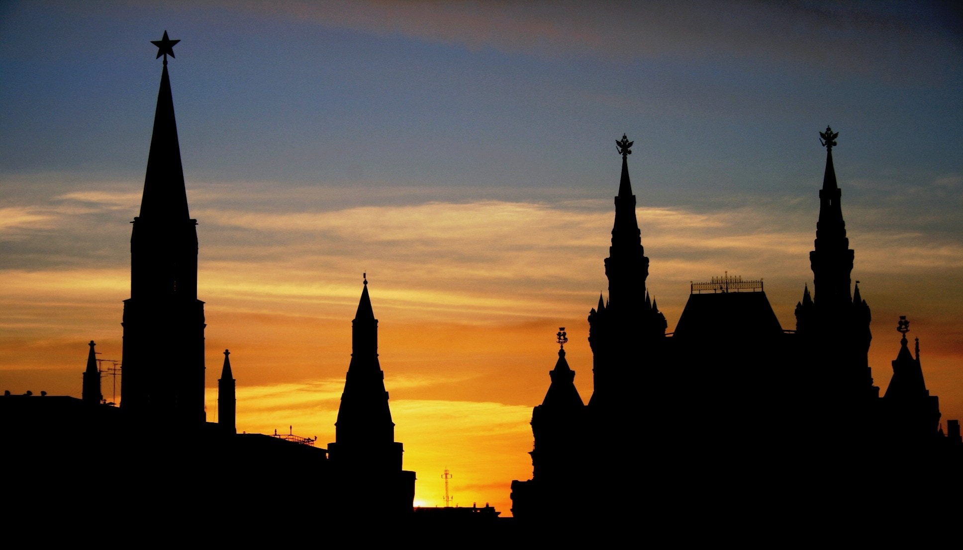 silhouette of castle with towers during sunset