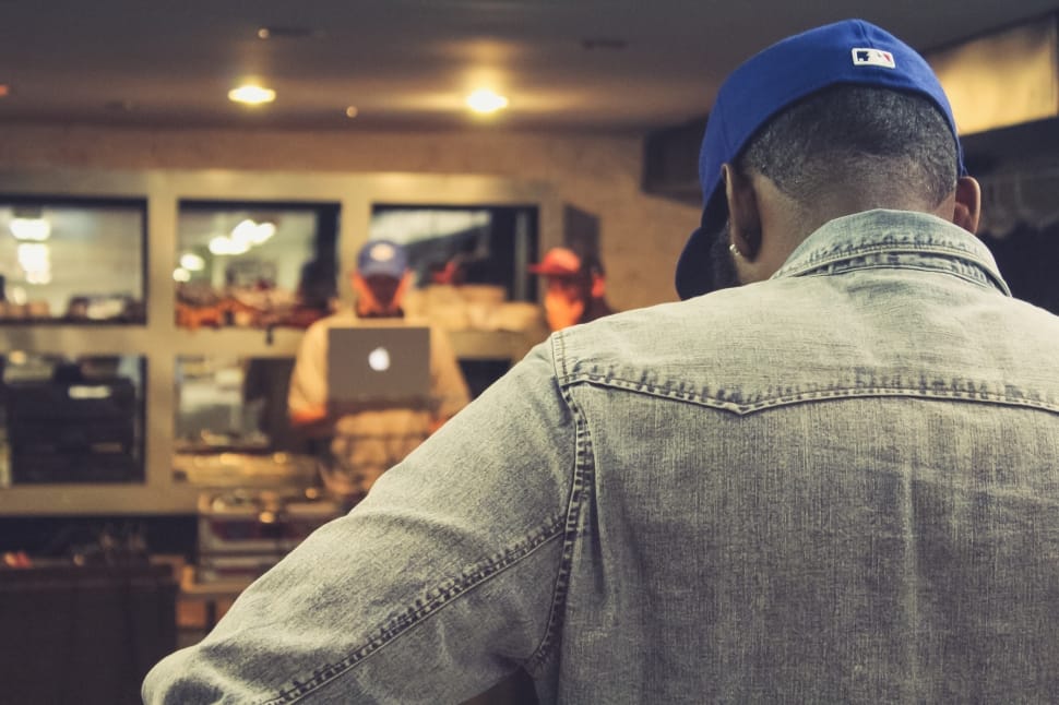 man in blue denim jacket wearing blue cap preview