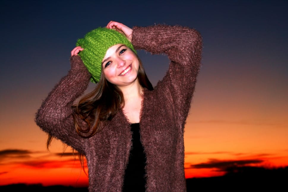 woman wearing brown coat during sunset preview