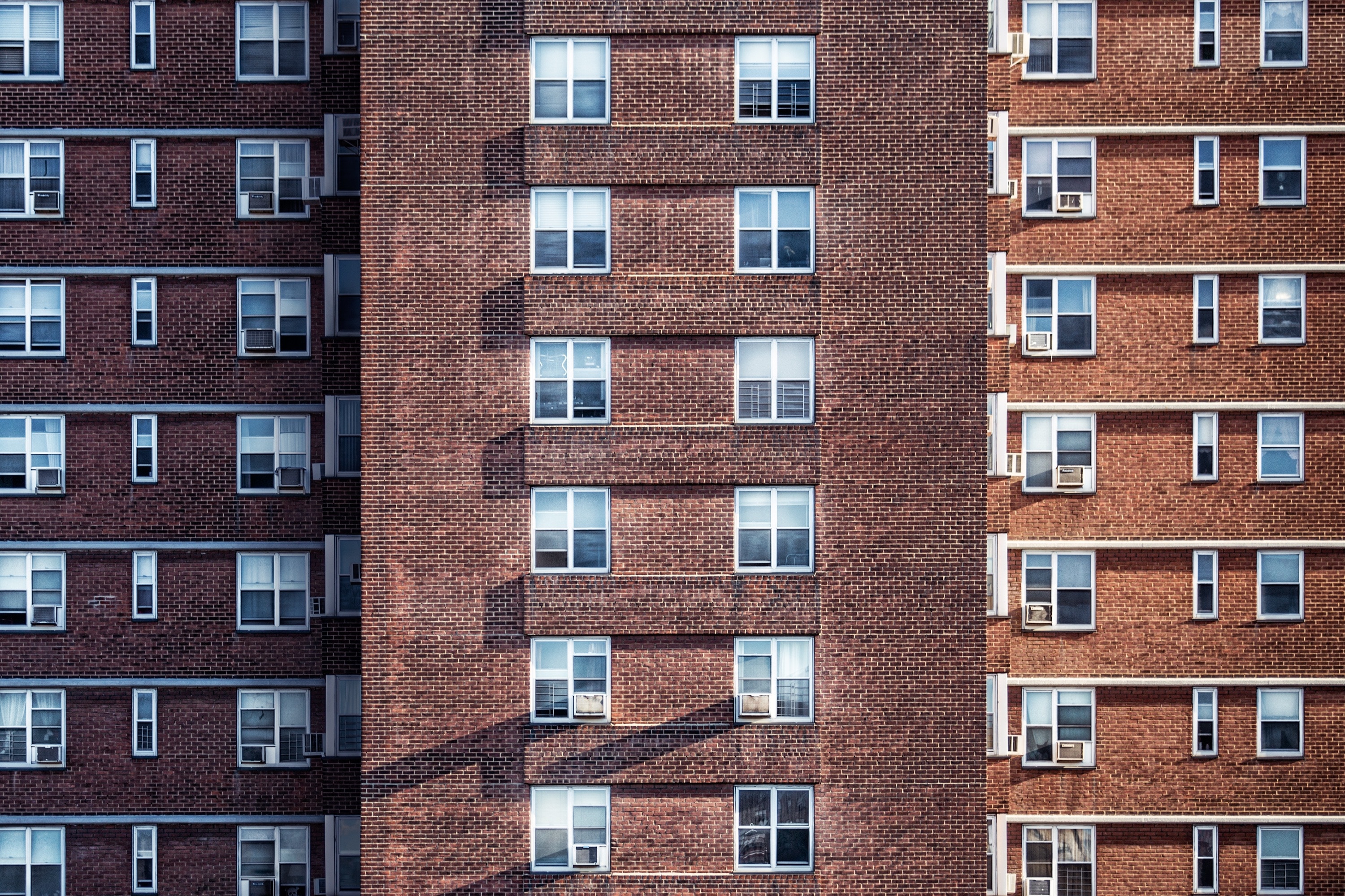 three brown concrete residential bildings