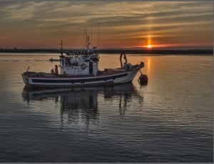 tug boat in the middle of body of water during daylight thumbnail