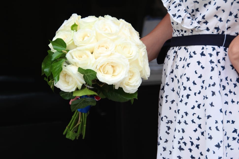 woman holding white bouquet of flowers preview