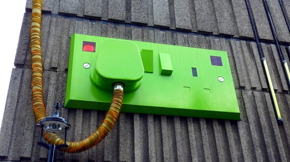 green power switch on gray wall preview