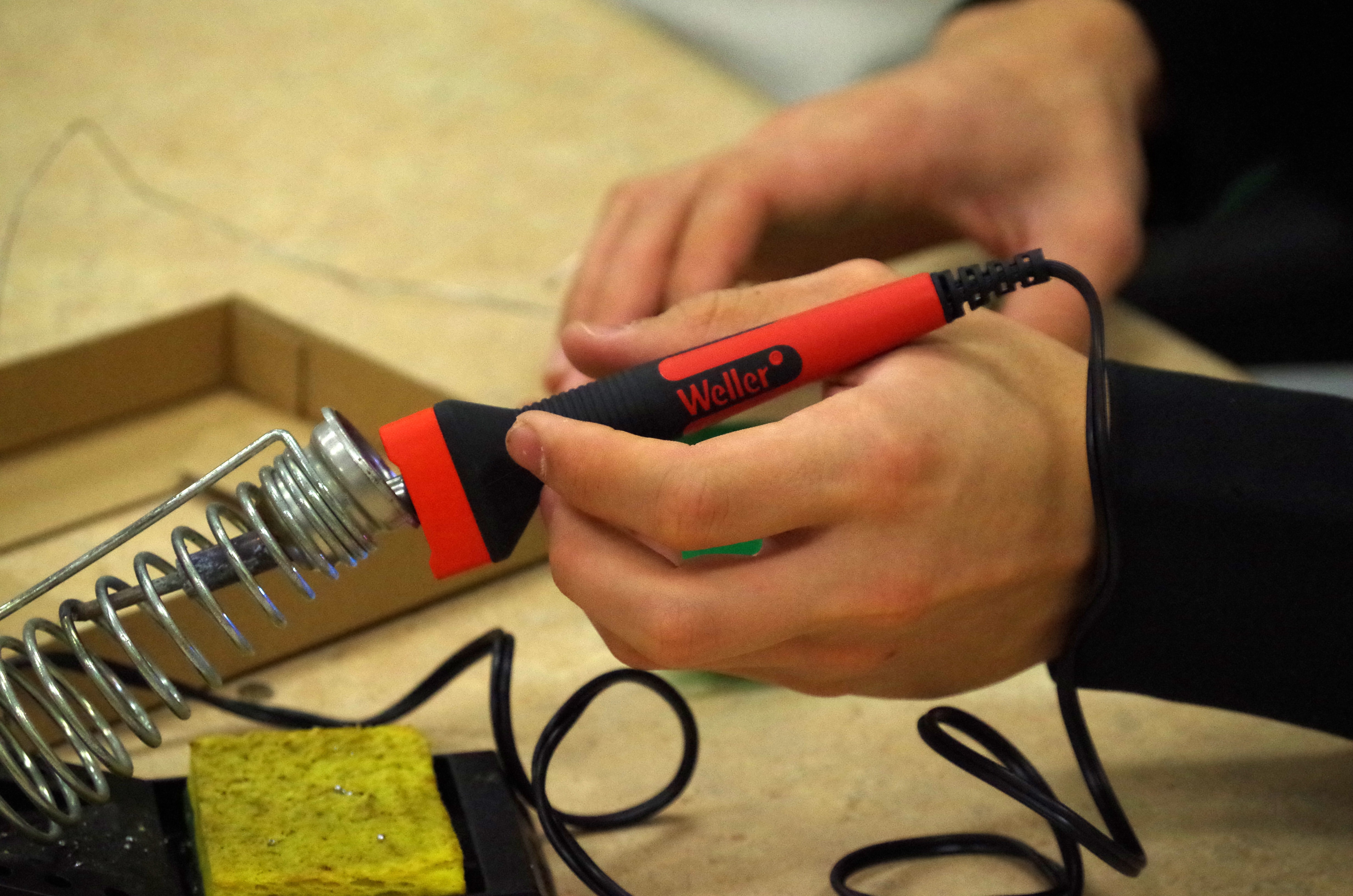 red and black soldering iron
