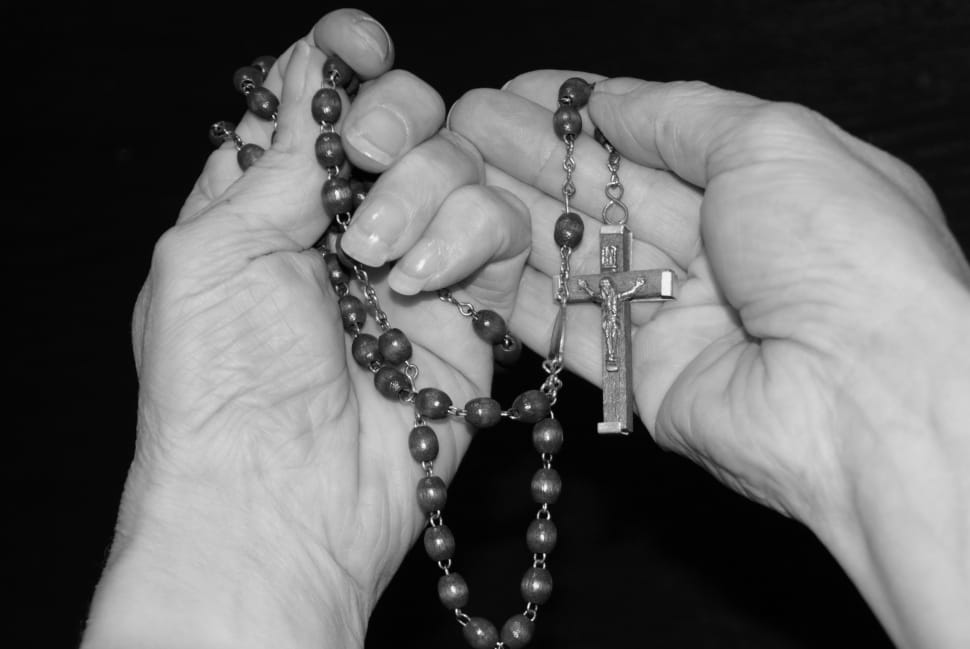 person holding rosary preview