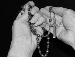person holding rosary thumbnail