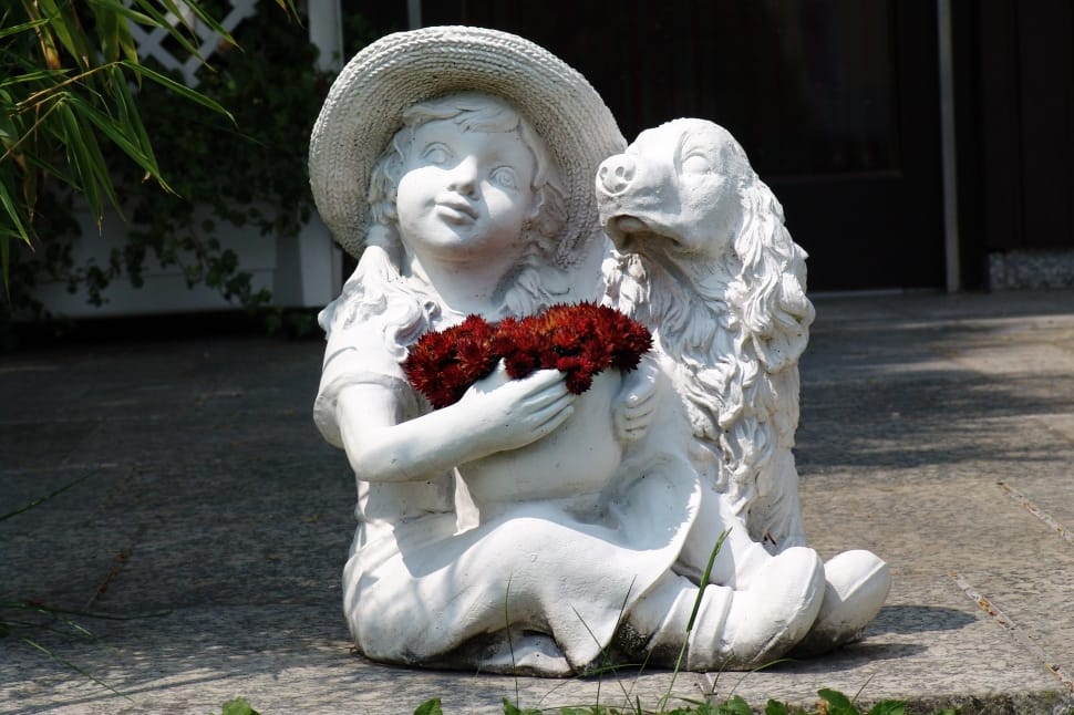 girl holding red flower bouquet beside the Cocker Spaniel statuette preview