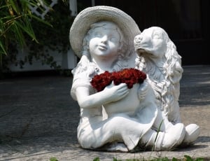 girl holding red flower bouquet beside the Cocker Spaniel statuette thumbnail