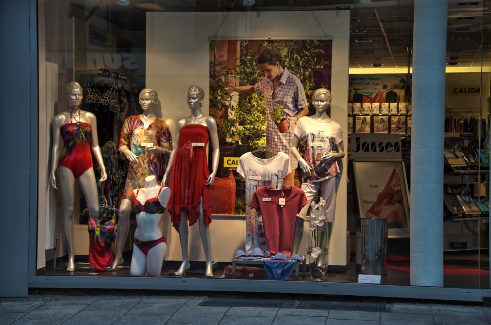 five manequines display inside the store with glass preview