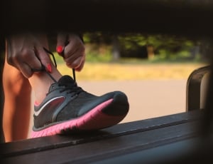 person holding lace of low top running shoes thumbnail