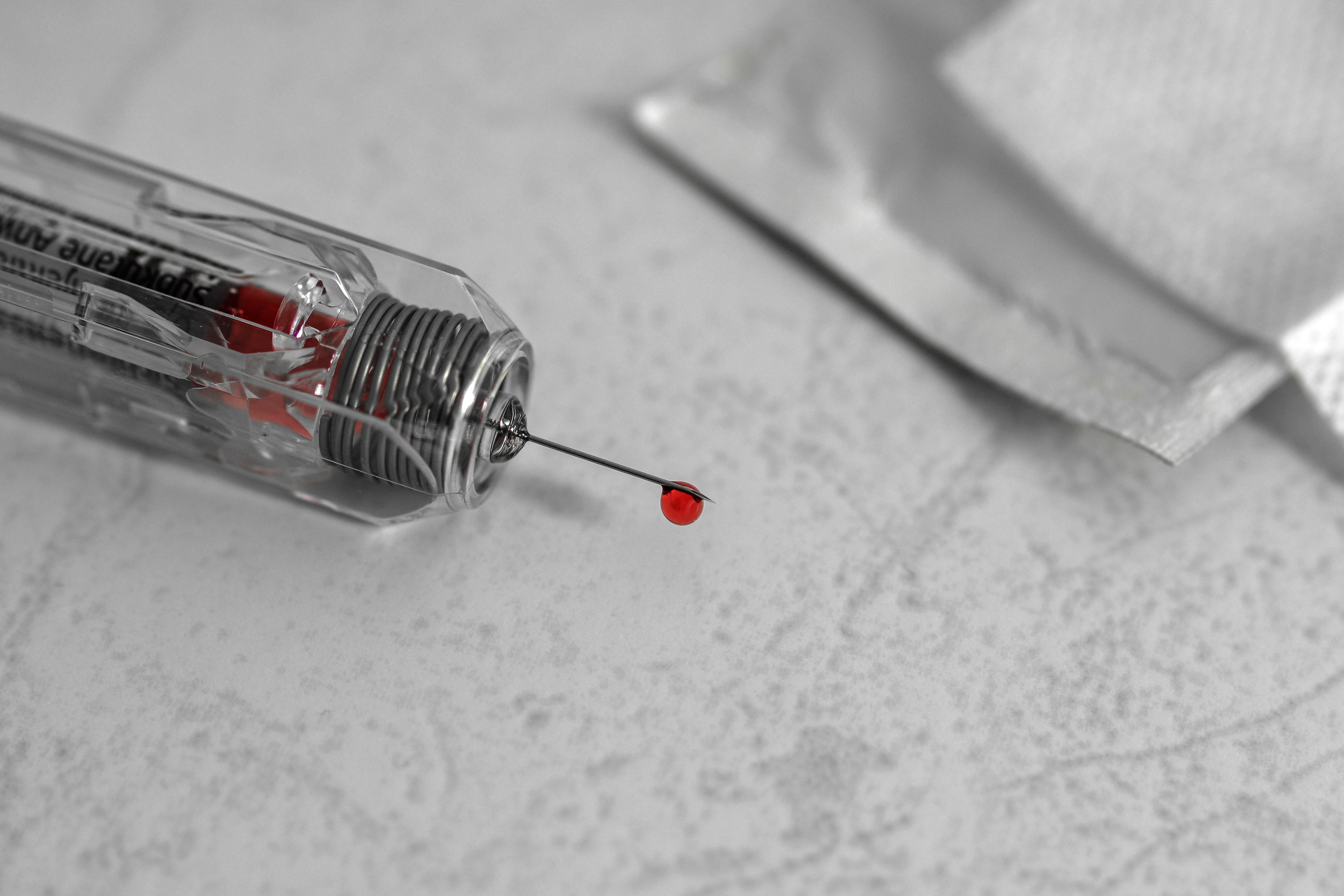 clear syringe with red liquid