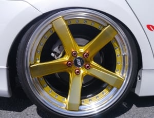 gold and silver 5-spoked automotive rims thumbnail