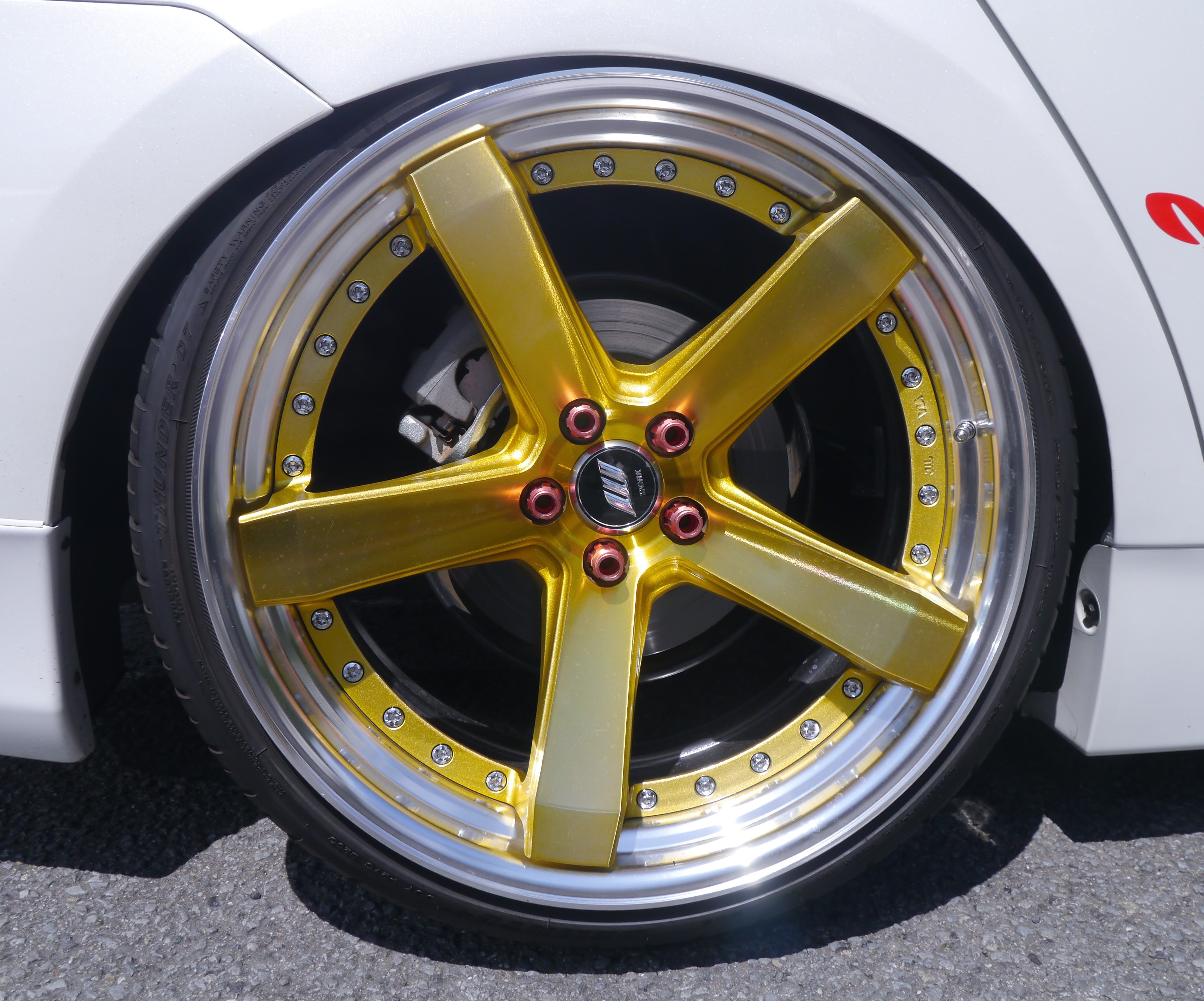 gold and silver 5-spoked automotive rims