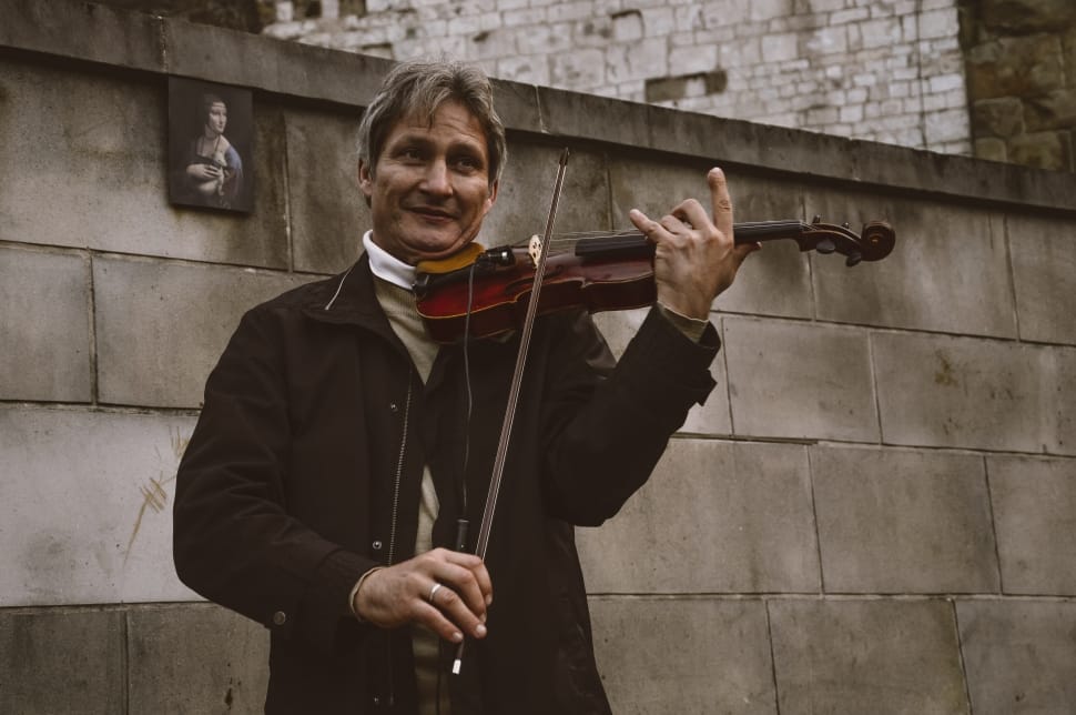 man playing violin on the streets preview