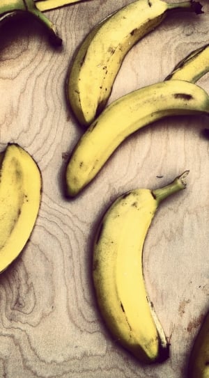 yellow bananas on top of brown wooden surface thumbnail