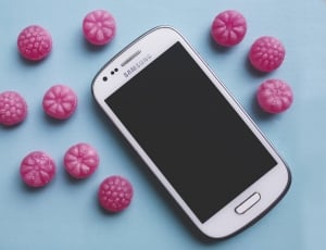 Pink candies and white smartphone thumbnail