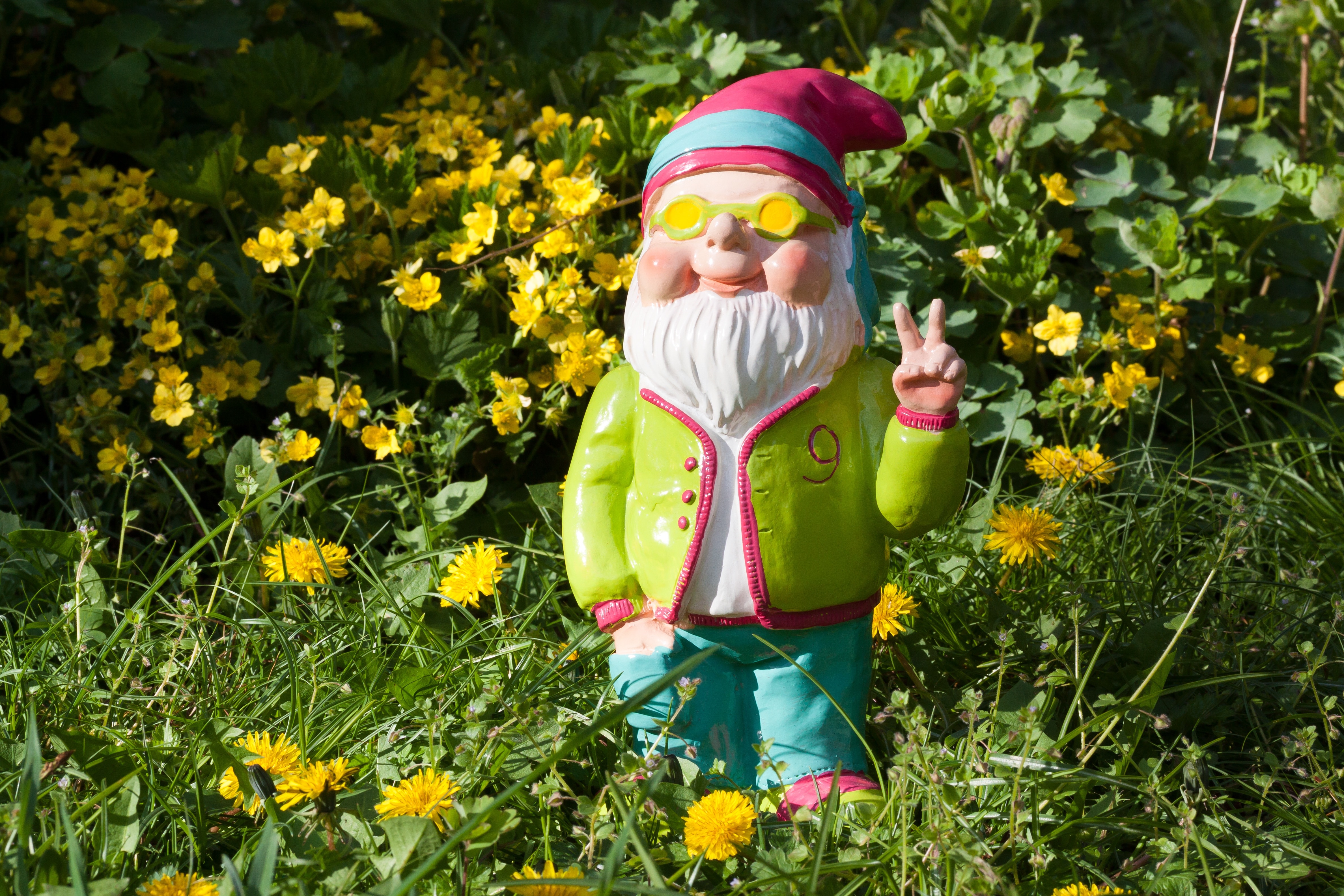 garden gnome doing hand peace sign statue