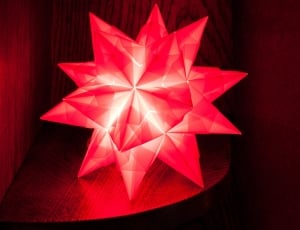 red star table lamp on brown wooden shelf thumbnail