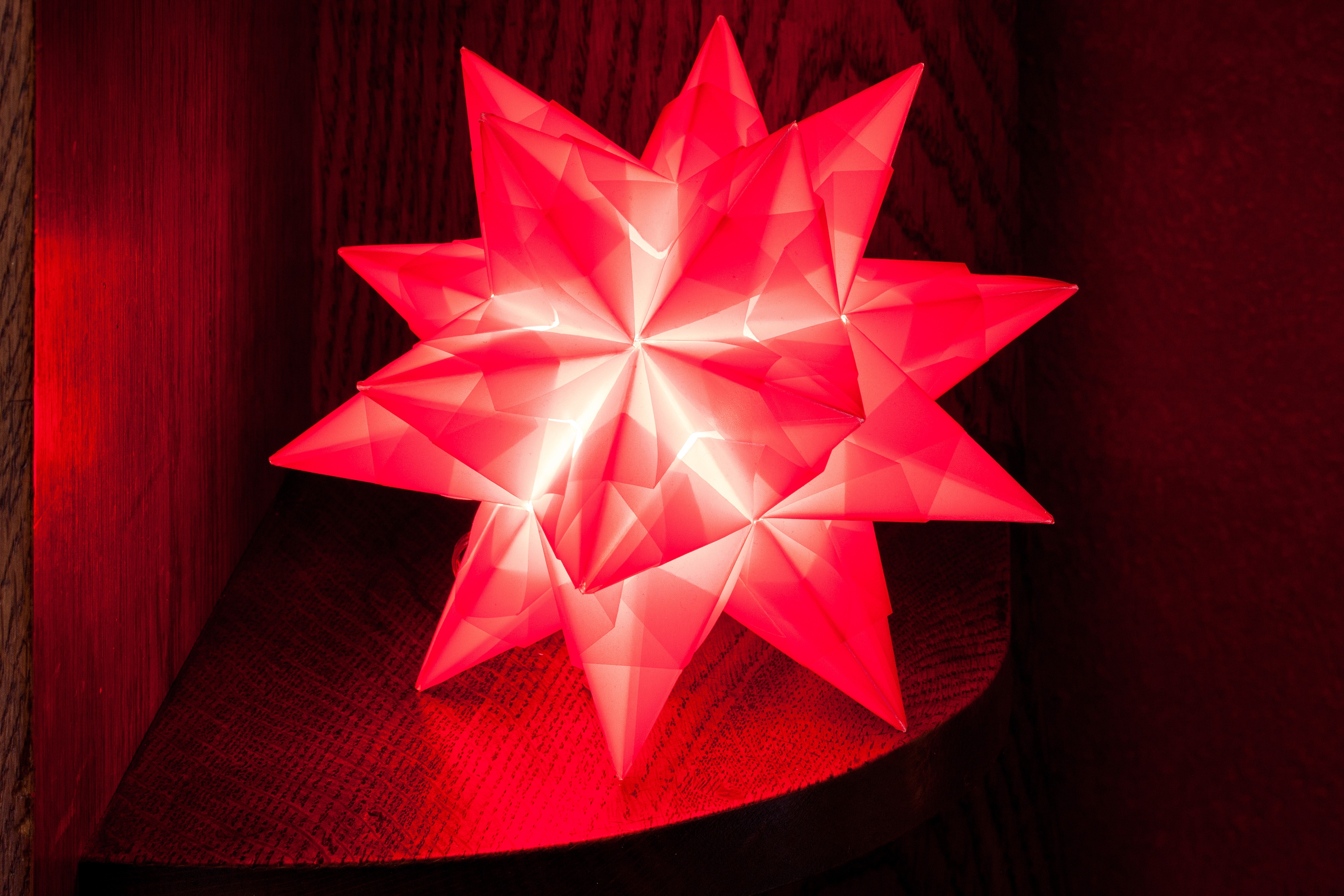 red star table lamp on brown wooden shelf