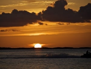 silhouette photo of sea during sunset thumbnail