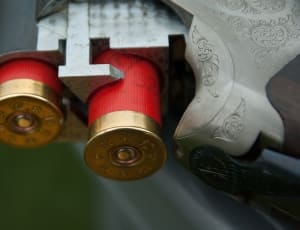 2 pcs red shotgun shells on a double barrel shotgun thumbnail