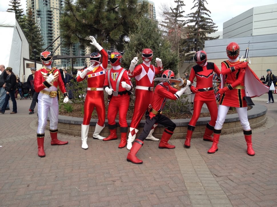 people on red power rangers costume during daytime preview