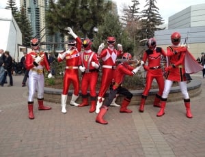 people on red power rangers costume during daytime thumbnail