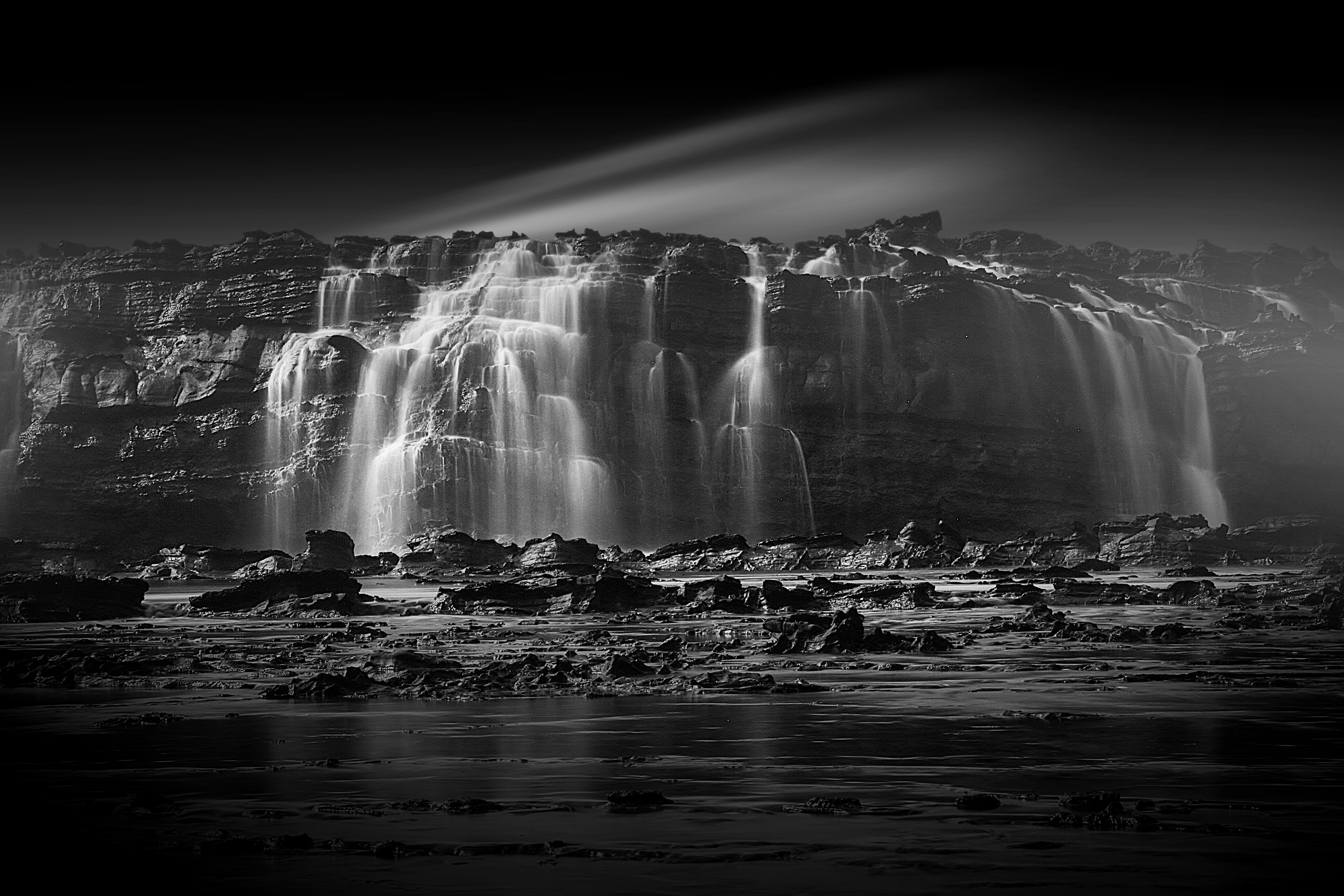 gray scale photo of waterfalls