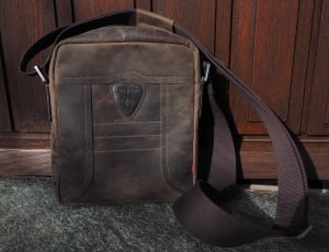 brown leather shoulder bag on gray and black fleece rug thumbnail