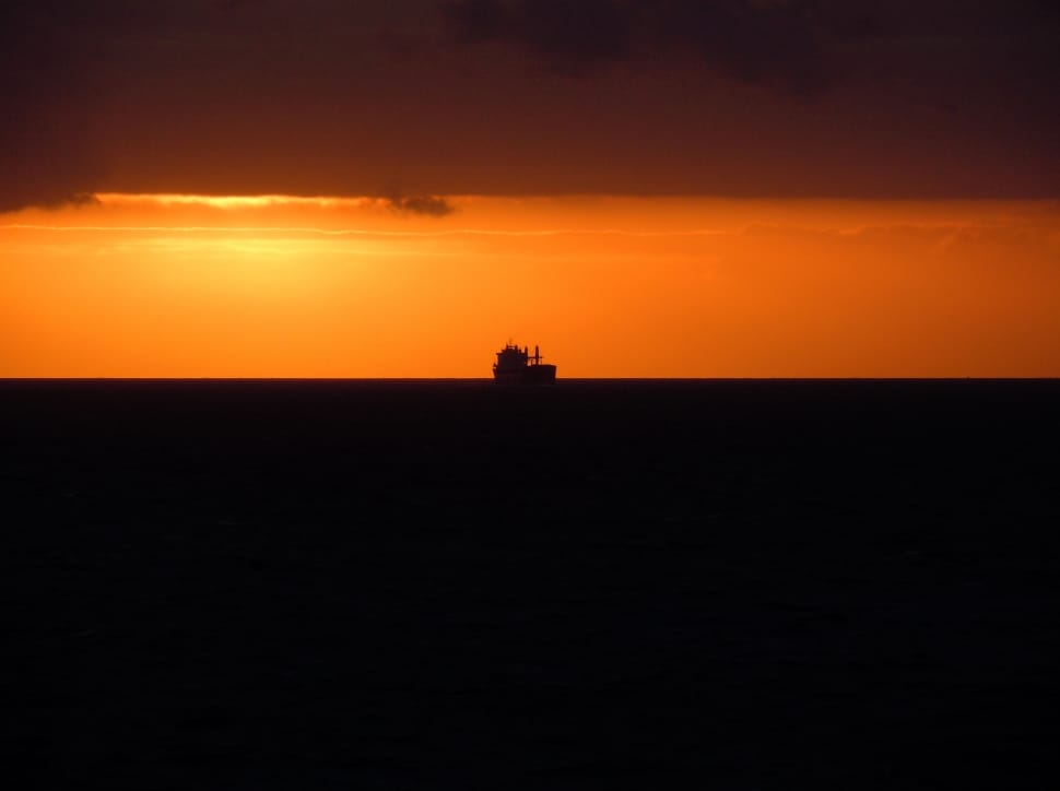 silhouette ship at sunset preview
