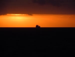 silhouette ship at sunset thumbnail
