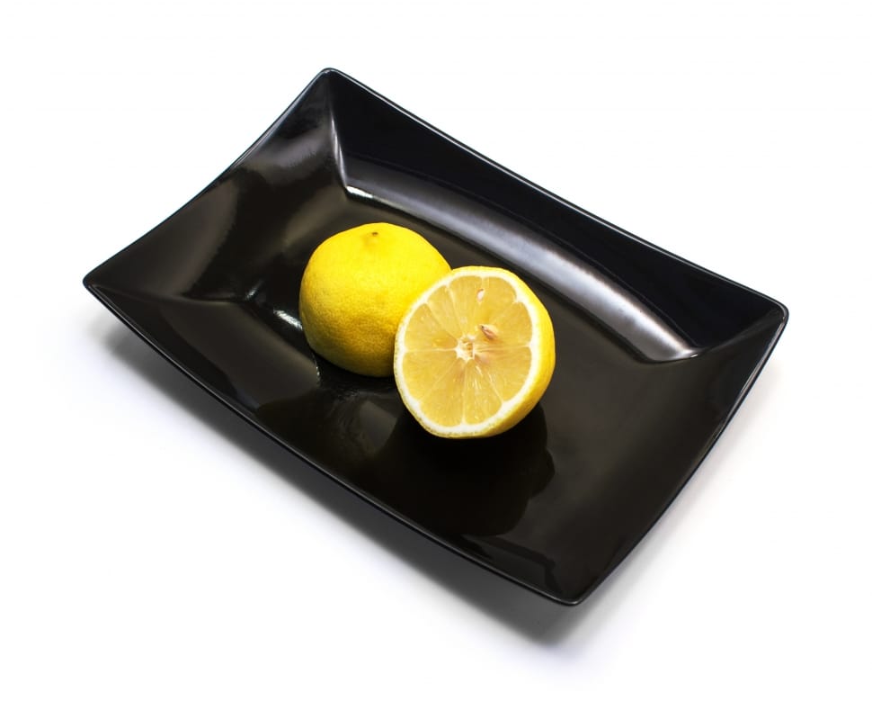 black ceramic plate with sliced lemon preview