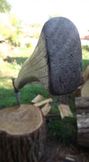 black wooden handle axe on brown wooden firewood thumbnail