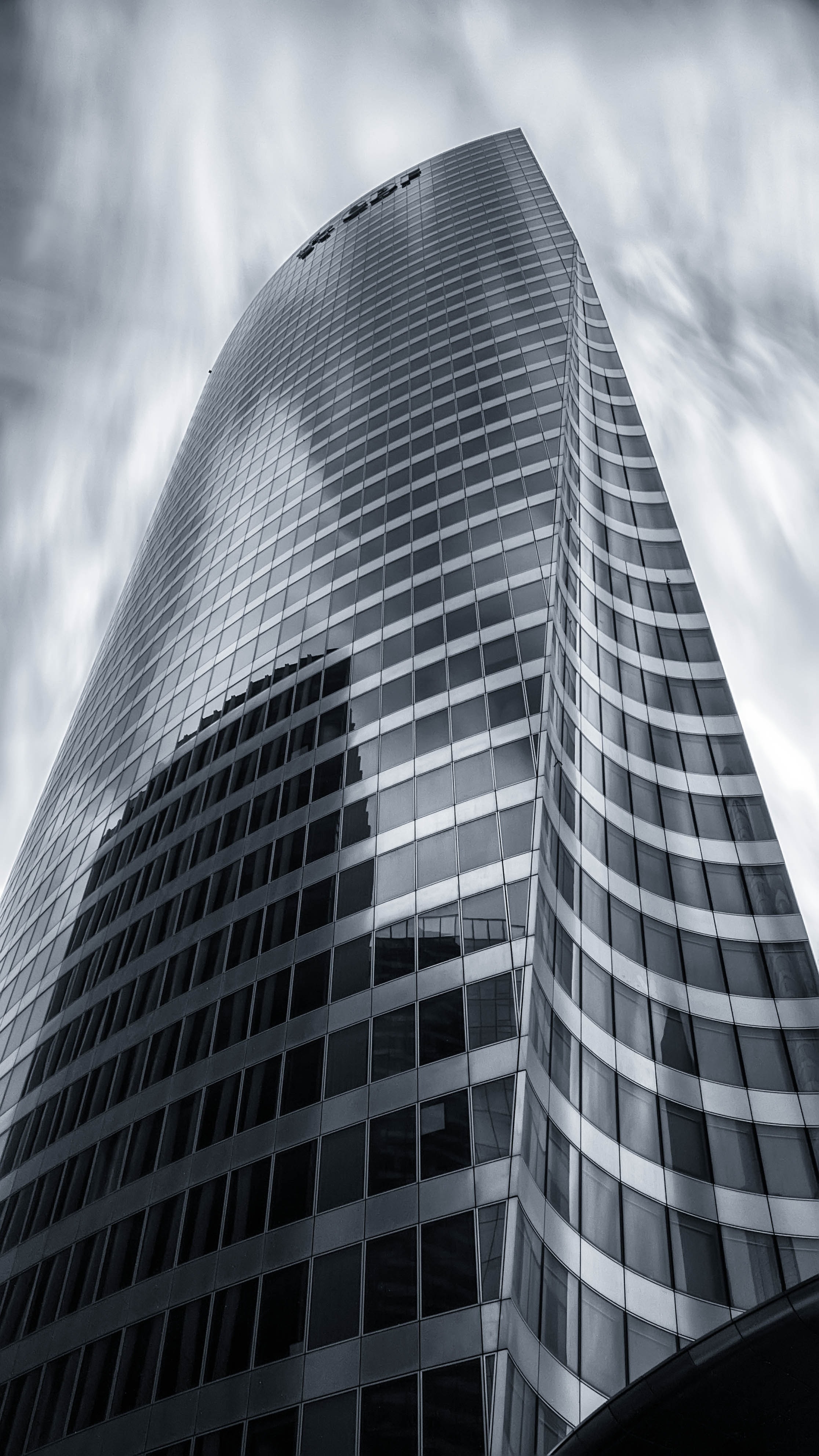grayscale photo of curtain wall high rise building
