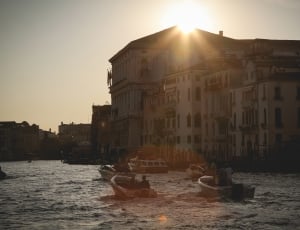 group of person riding on speed boats near city during sunse thumbnail