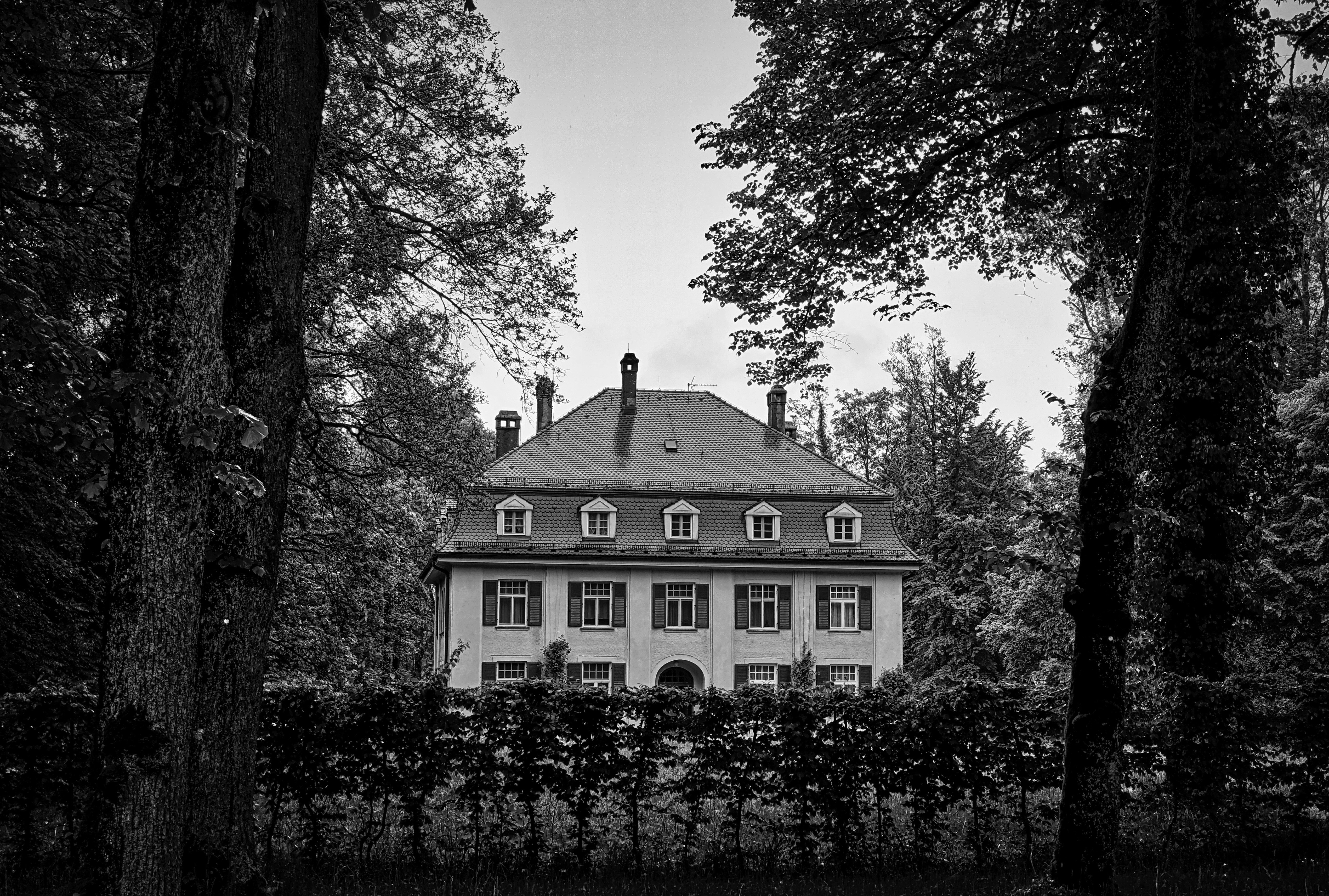 greyscale photo of 3 storey house