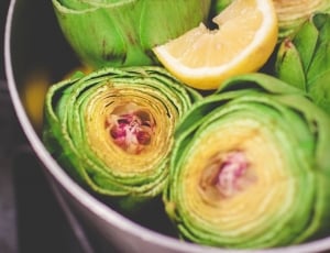 sliced lemon on top of green vegetables thumbnail