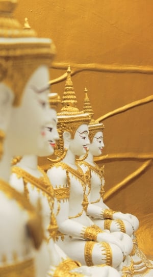 four white and gold ceramic buddha figurines thumbnail