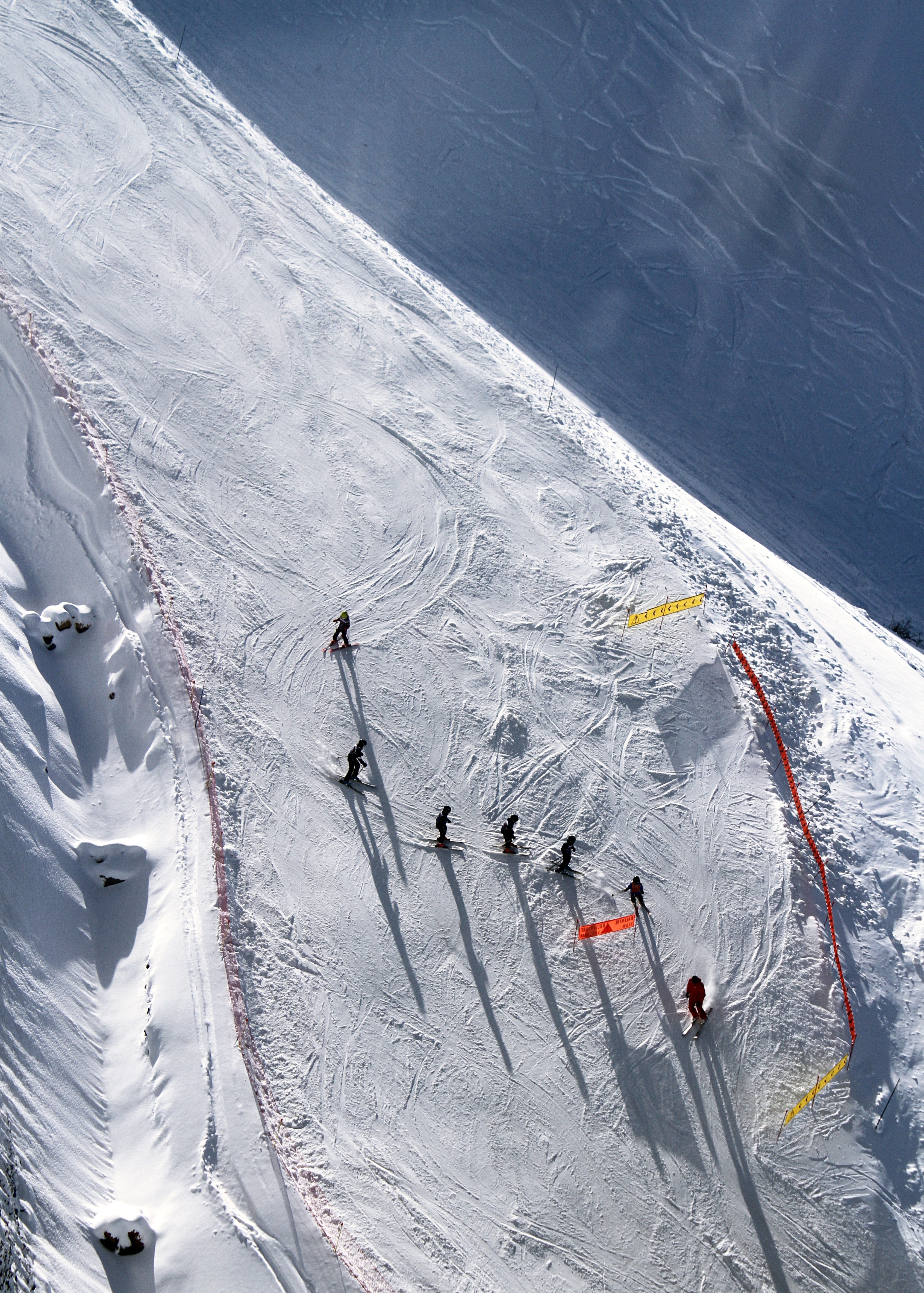 group of people playing ski on snow field in aerial photography