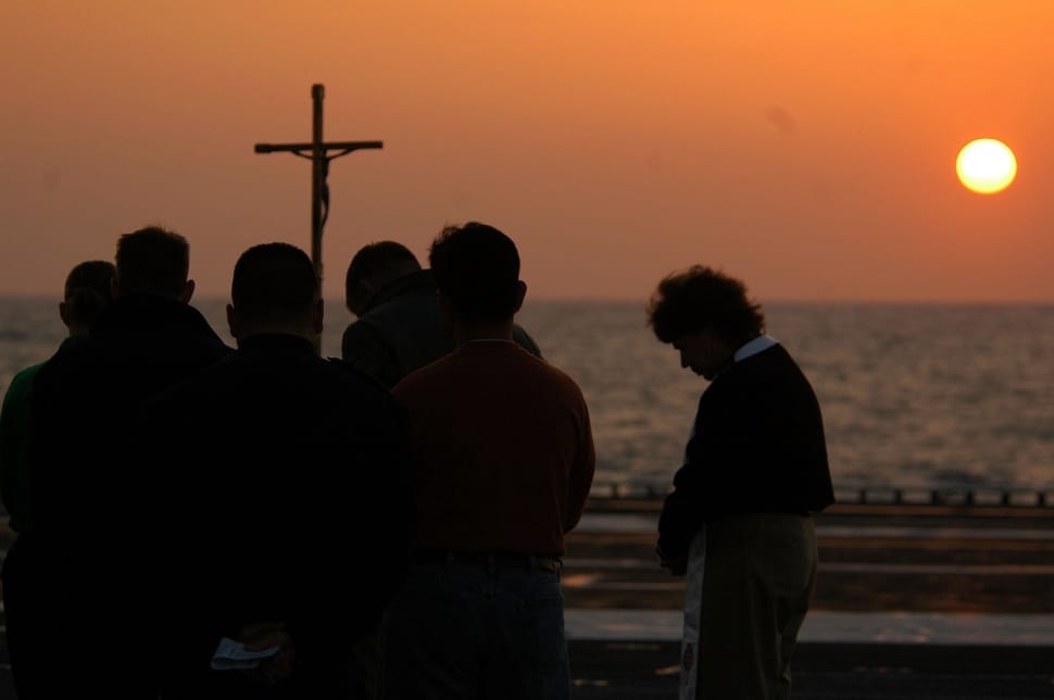 silhouette photo of group of people praying during sunset preview