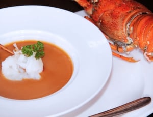 lobster with sauce on white ceramic round plate thumbnail