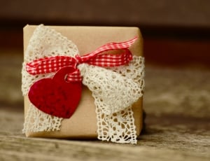 brown box with white and red textile on brown wooden board thumbnail