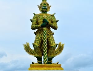 green and brown dragon statue thumbnail